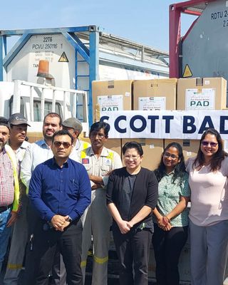 "Team of professionals at Scott Bader manufacturing facility with storage tanks for resins and composites production" [G]