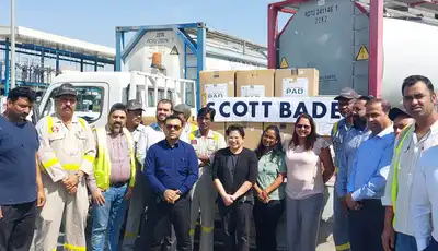 "Team of professionals at Scott Bader manufacturing facility with storage tanks for resins and composites production" [G]