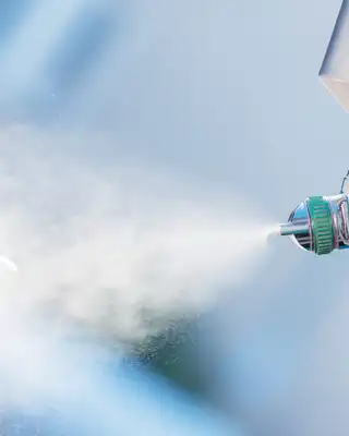 "Close-up of spray application equipment applying Scott Bader gelcoats with Crystic® branding for composite manufacturing" [G]
