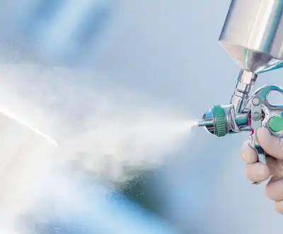 "Close-up of spray application equipment applying Scott Bader gelcoats with Crystic® branding for composite manufacturing" [G]