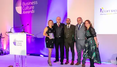 "Scott Bader representatives receiving an award at the Business Culture Awards ceremony, showcasing company excellence" [G]