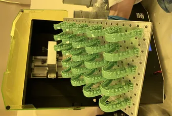 "Green translucent composite parts arranged on a manufacturing rack, showcasing Scott Bader resins for precision production" [G]