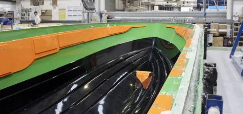 Boat hull mold with green gelcoat finish, showcasing Scott Bader gelcoats and composites in marine manufacturing. [G]