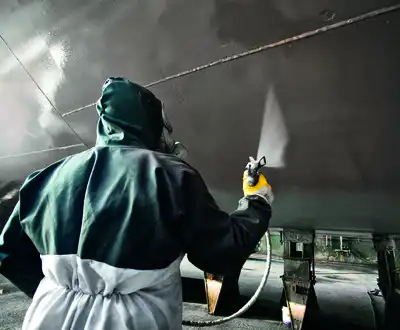 "Worker applying Scott Bader gelcoats to boat hull in manufacturing facility, showcasing marine composites application" [G]