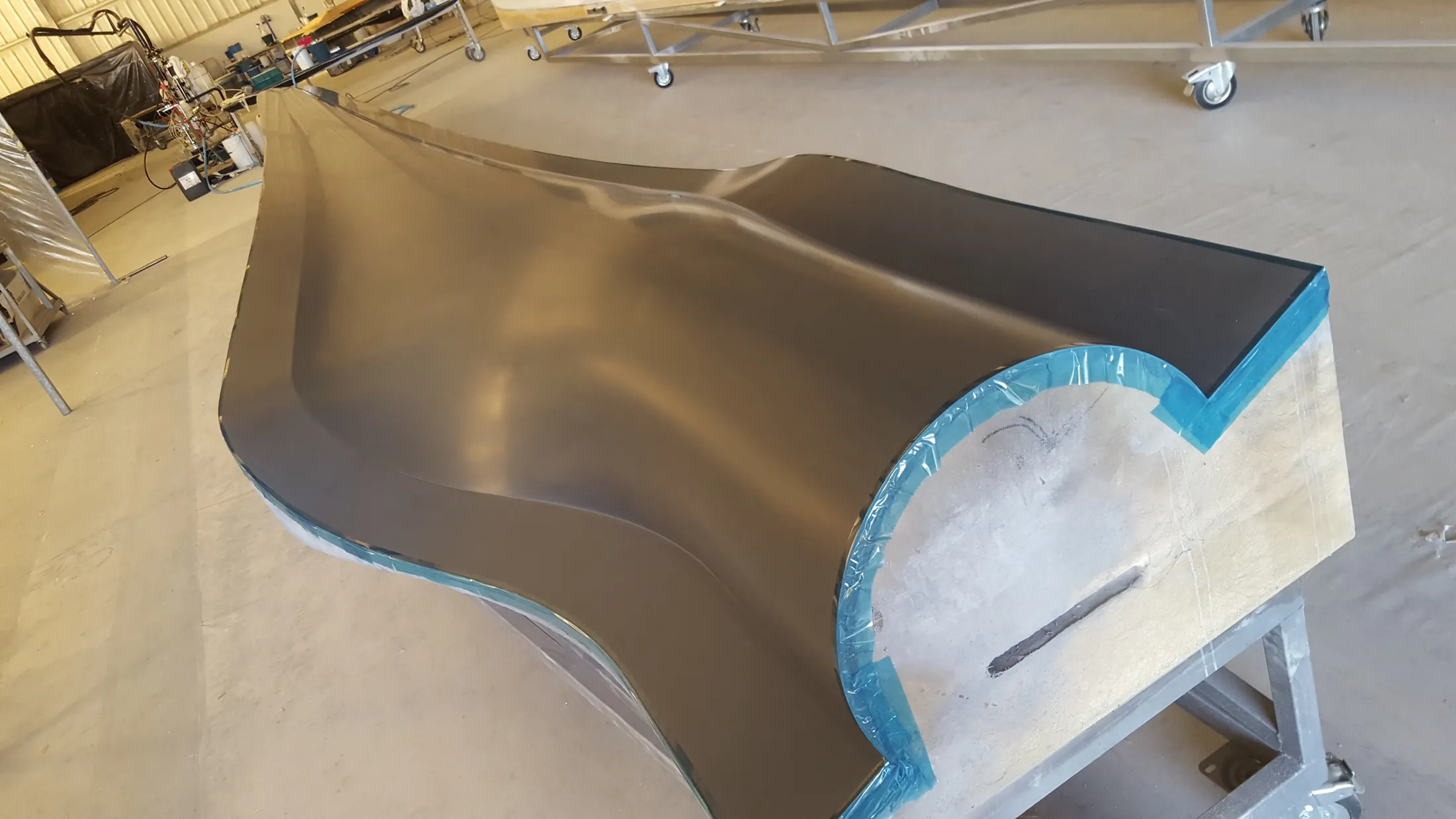 "Sleek composite component with blue edge detail in Scott Bader manufacturing facility, showcasing gelcoats for industrial applications" [G]