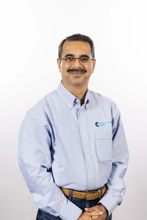 Professional in light blue button-up shirt with Scott Bader logo, representing the company's composites and adhesives expertise [G]