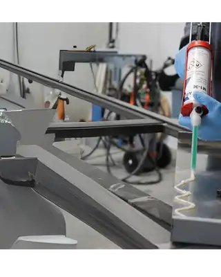 "Technician applying Scott Bader structural adhesives in precision manufacturing process for composite materials assembly" [G]