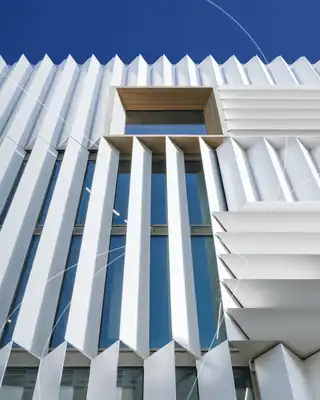 "Modern architectural facade with white composite panels by Scott Bader, showcasing structural materials for building applications" [G]