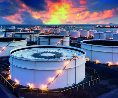 "Industrial storage tanks at sunset with vibrant sky, where Scott Bader resins and composites provide protective solutions" [G]