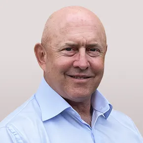 "Professional portrait of a team member in a light blue shirt against a neutral background" [G]