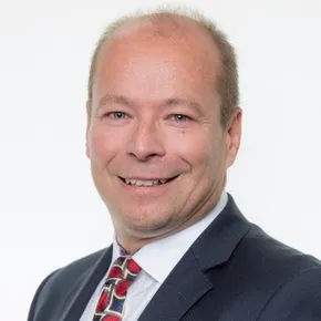 Professional headshot of a smiling man in a suit, representing Scott Bader leadership team. [G]