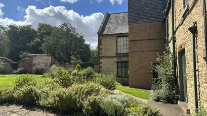 Historic stone building and garden at Scott Bader headquarters, home of composites and resins innovation [G]