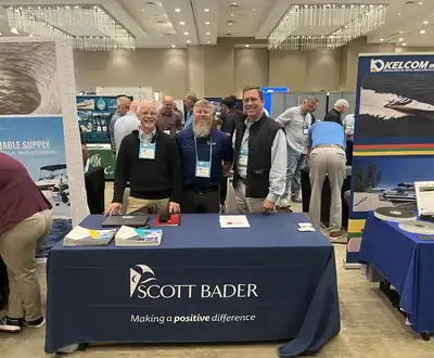 "Scott Bader representatives at industry exhibition showcasing composites and resins for marine applications" [G]