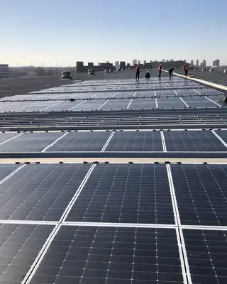 "Solar panel installation on commercial rooftop with city skyline in background, showcasing durable composite materials" [G]