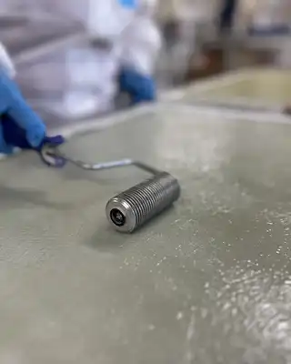 "Technician applying Scott Bader gelcoats to a surface using a roller for smooth, protective composite finishing" [G]