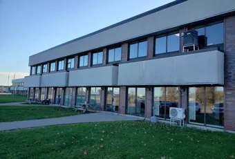 "Modern industrial facility with large windows, likely a Scott Bader manufacturing or office location" [G]