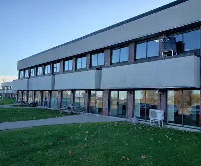 "Modern industrial facility with large windows, likely a Scott Bader manufacturing or office location" [G]