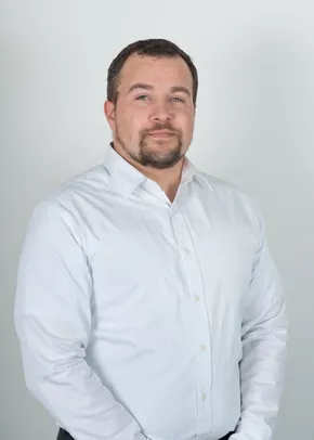 Professional portrait of a Scott Bader team member in a white button-up shirt against a light background [G]