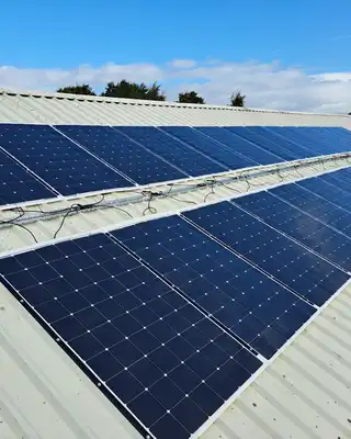Solar panels installed on a metal roof structure under blue sky, showcasing durable composite materials from Scott Bader [G]