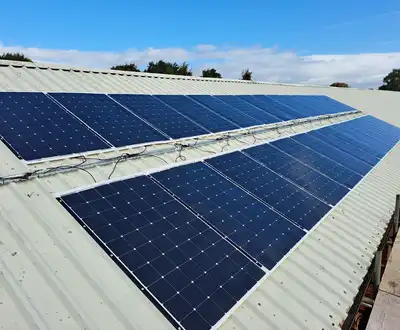 Solar panels installed on a metal roof structure under blue sky, showcasing durable composite materials from Scott Bader [G]