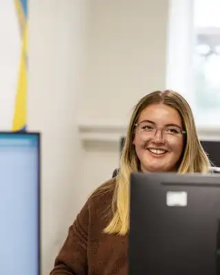 "Professional in bright office environment with Scott Bader branding visible, showcasing the company's composites expertise" [G]