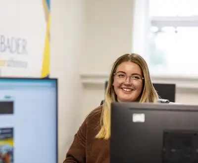 "Professional in bright office environment with Scott Bader branding visible, showcasing the company's composites expertise" [G]