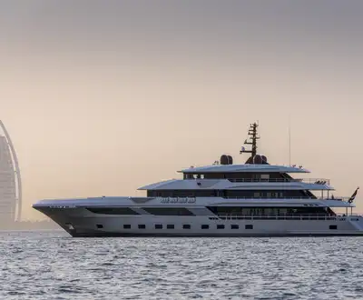 "Luxury yacht on water with Dubai's Burj Al Arab in background, showcasing Scott Bader composites and gelcoats for marine applications" [G]