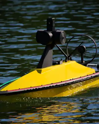 "Yellow unmanned marine vessel on water, featuring Scott Bader composites and gelcoats for watercraft durability" [G]