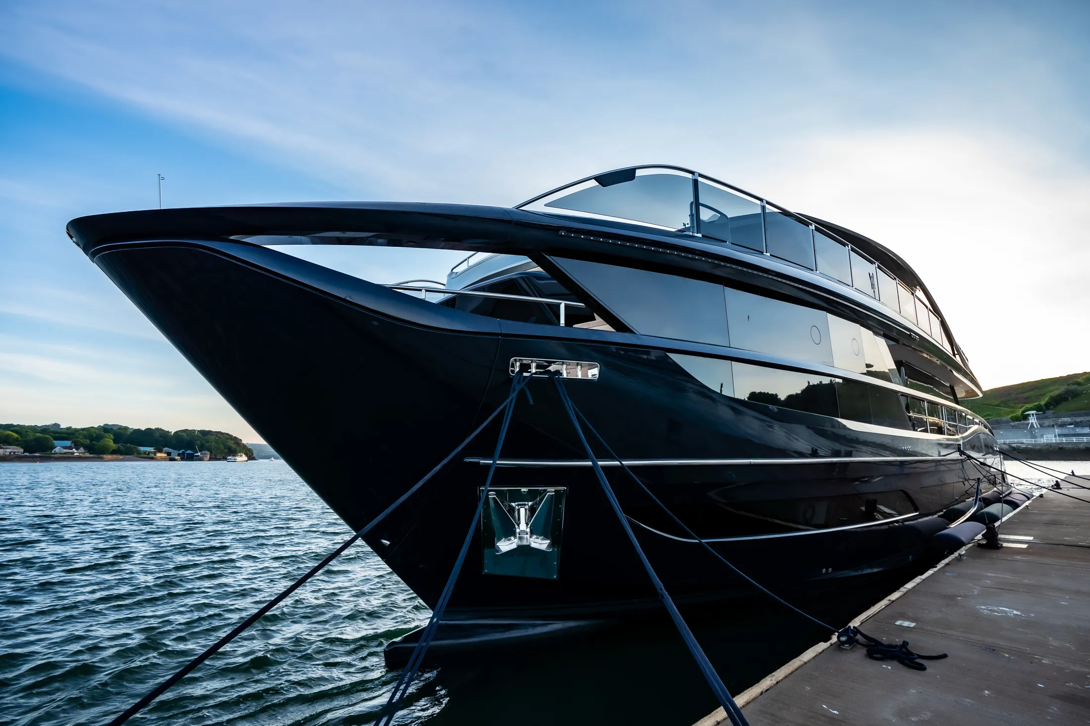 "Sleek luxury yacht with glossy black hull docked at marina - Scott Bader gelcoats and composites for marine applications" [G]