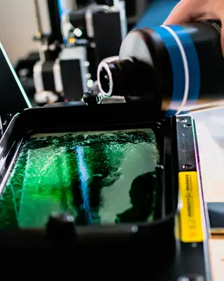 "Pouring green Scott Bader resin into manufacturing equipment for composite production process" [G]
