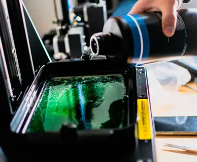 "Pouring green Scott Bader resin into manufacturing equipment for composite production process" [G]