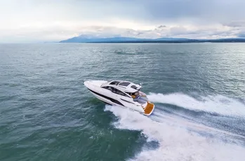 White motor yacht speeding on open water, built with Scott Bader gelcoats and composites for marine use [G]
