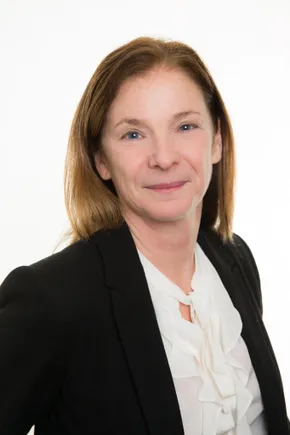 Professional portrait of a Scott Bader team member in a black blazer and white blouse against a white background. [G]