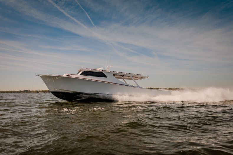 "Sleek white speedboat racing across water, showcasing Scott Bader gelcoats and composites used in marine applications" [G]