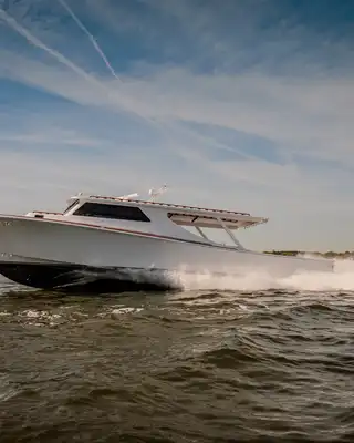 "Sleek white speedboat racing across water, showcasing Scott Bader gelcoats and composites used in marine applications" [G]