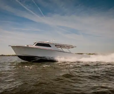 "Sleek white speedboat racing across water, showcasing Scott Bader gelcoats and composites used in marine applications" [G]