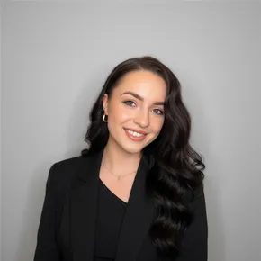 Professional headshot of a smiling woman in a black blazer, part of the Scott Bader team. [G]