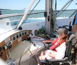 Girl steering a boat built with Scott Bader gelcoats and composites for marine applications [G]