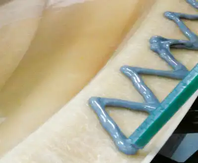 "Application of Scott Bader gelcoats on a smooth composite surface, showcasing the finishing process for marine materials" [G]