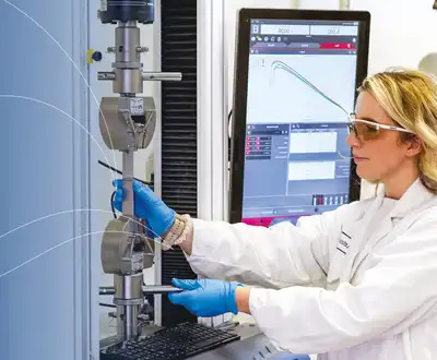 "Laboratory technician in protective gear testing materials at Scott Bader's facility for quality control of resins and composites" [G]