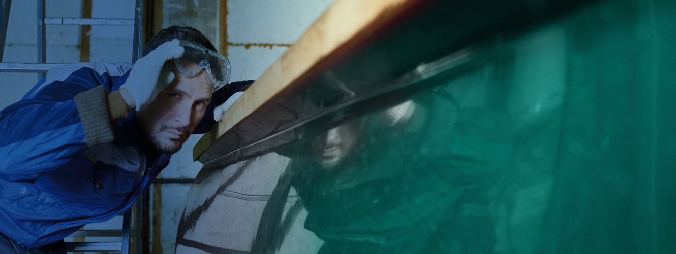 "Worker applying Scott Bader gelcoat to a large green surface, showcasing precision application of composites in manufacturing" [G]