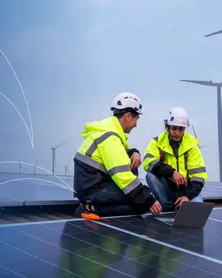 "Technicians installing solar panels at renewable energy site with wind turbines, using Scott Bader composites and structural adhesives" [G]