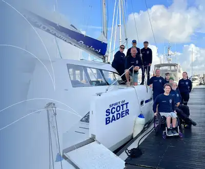 "Group on marina dock beside Scott Bader branded yacht, showcasing gelcoats and composites used in marine applications" [G]