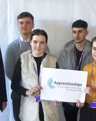 "Group of professionals at an apprenticeship event with Scott Bader representatives showcasing career opportunities in composites and resins" [G]
