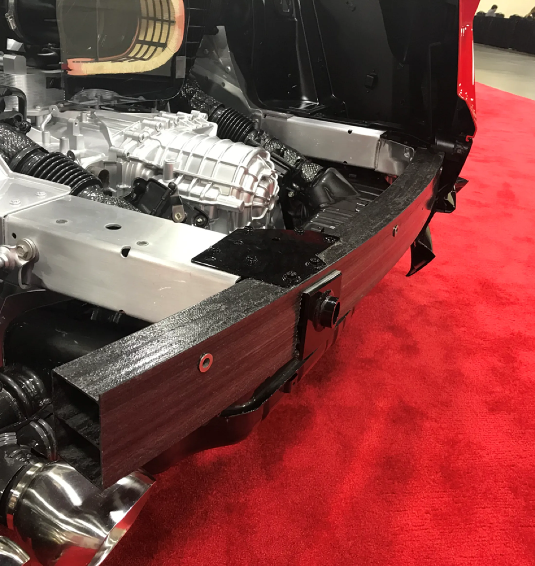 "Vehicle engine compartment showcasing Scott Bader composites and structural adhesives in automotive application" [G]