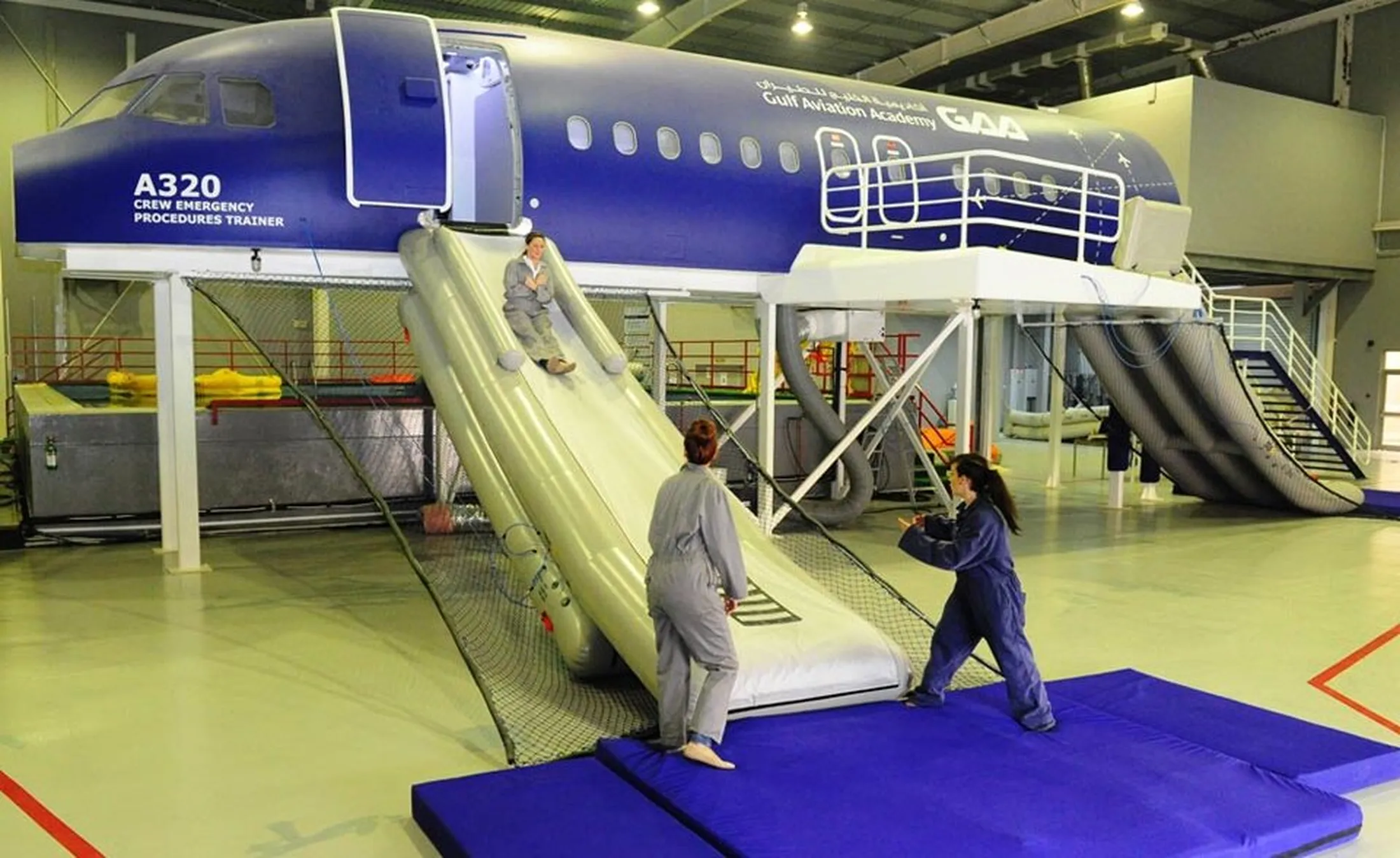 "Aircraft evacuation training facility with emergency slide demonstration, showcasing applications for Scott Bader composites and resins" [G]