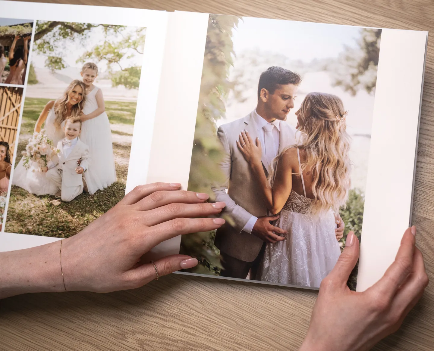 Hands holding a wedding photo album, featuring a couple in wedding attire embracing and a family portrait on the adjacent page.
