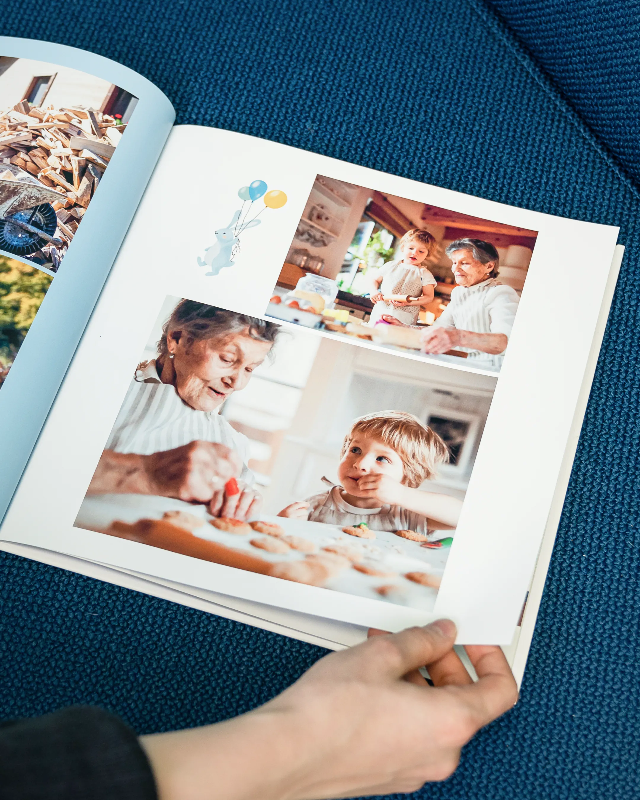 A person holds an open photo album showing images of a child and an older woman baking together, with a drawing of a rabbit with balloons.