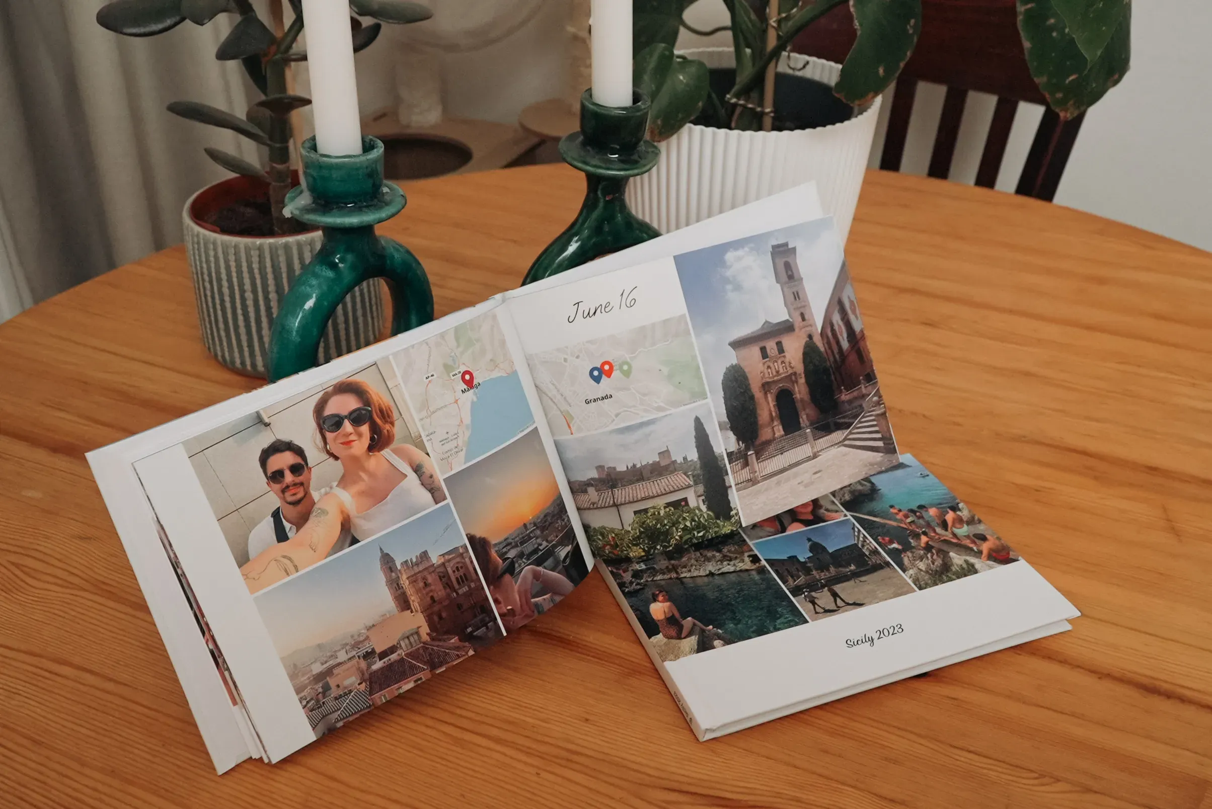 Photo album on a wooden table, open to pages showing travel photos and "June 16" text. Green candle holders in the background.