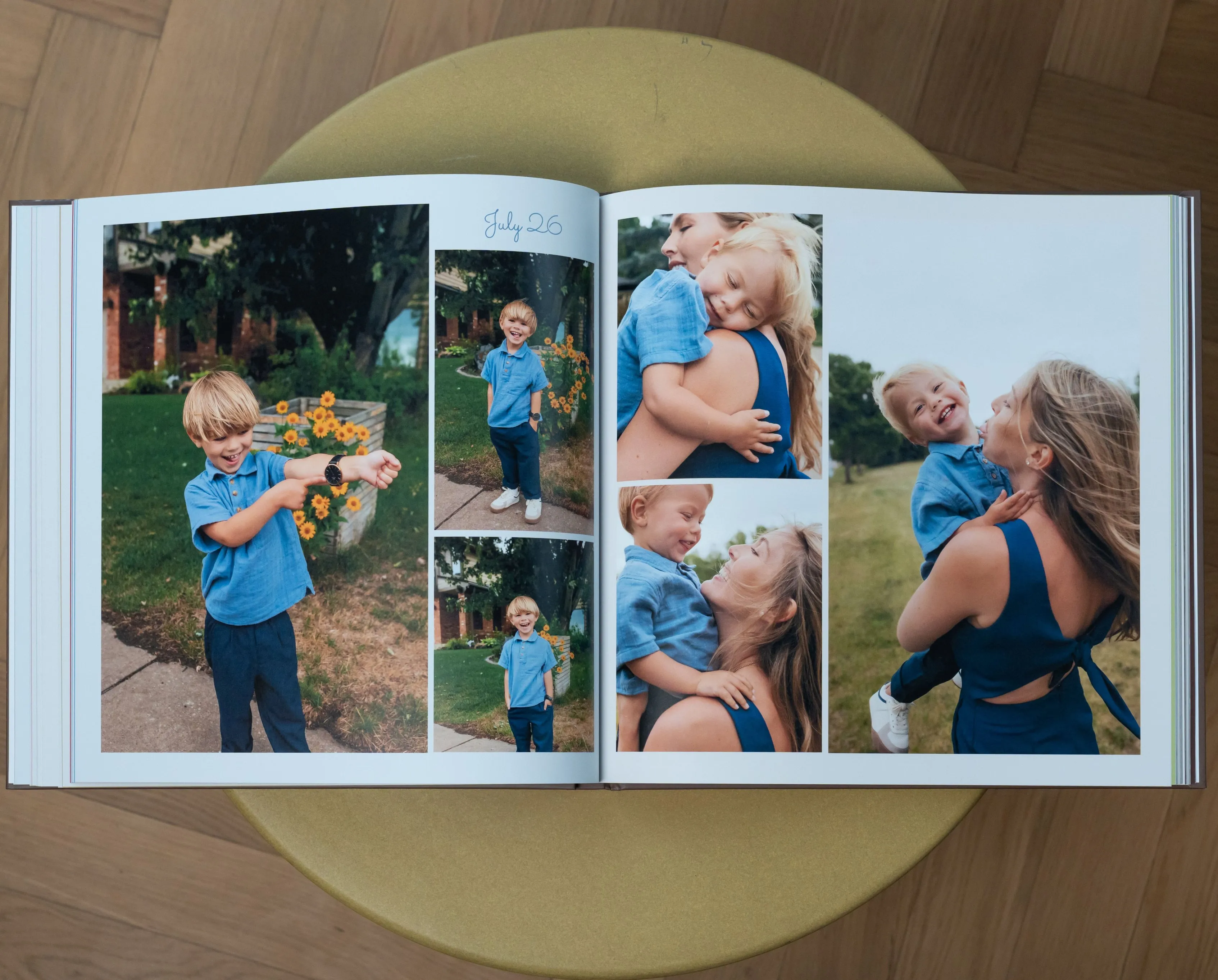 Open photo album on a table, displaying pictures of a child and woman outdoors, smiling and embracing.
